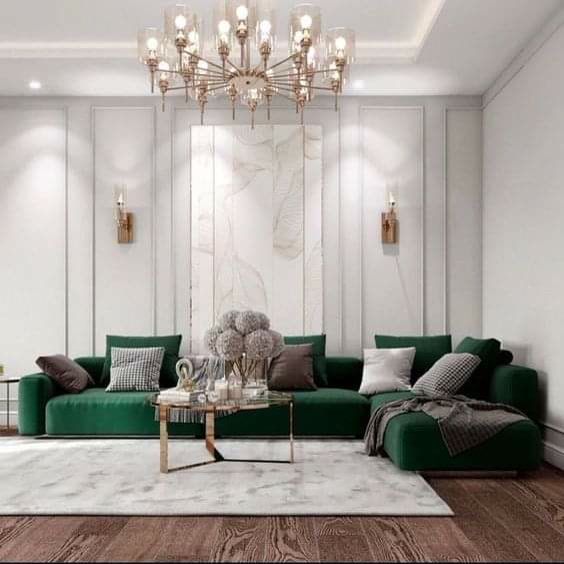Profil Poliuretan P85008 pentru Ancadramente Perete Profilele decorative din poliuretan P85008 reprezintă elemente arhitecturale de mare densitate destinate structurării geometrice a pereților interiori prin ancadramente și casete decorative. În acest proiect de living modern, casetele utilizate pe peretele principal au fost realizate prin debitarea la unghi de 45 de grade a baghetelor din poliuretan, obținându-se panouri verticale simetrice ce accentuează înălțimea încăperii. Utilizarea materialelor din poliuretan cu o densitate medie de 150-220 kg/m³ (țintă ~160 kg/m³) garantează o stabilitate dimensională excelentă, prevenind dilatarea sau contracția structurală cauzată de fluctuațiile de temperatură ambientală.

Pentru fixarea mecanică și adezivă a profilului P85008 pe suprafața din gips-carton sau tencuială, se utilizează adezivi structurali pe bază de polimeri hibrizi cu aderență inițială ridicată. La îmbinările de colț și la rosturile dintre baghete, aplicarea unui adeziv special de sudură la rece pentru poliuretan împiedică apariția fisurilor în timp. După uscarea completă a adezivului, suprafețele de contact se șlefuiesc fin cu hârtie abrazivă de granulație 220, iar rosturile de dilatație marginale sunt etanșate cu mastic acrilic zugrăvibil, asigurând o tranziție lină și fără denivelări între perete și profilul decorativ.

Spre deosebire de profilele clasice din ipsos sau lemn, poliuretanul de înaltă densitate prezintă o rată de absorbție a apei de sub 1%, ceea ce îl face extrem de rezistent la umiditate și la impact mecanic accidental. De asemenea, rezistența termică cuprinsă între -100 °C / +80 °C permite montarea sigură a lămpilor de perete în imediata apropiere a ancadramentelor, fără riscul de deformare sau îngălbenire a profilului. Flexibilitatea controlată a profilului P85008 preia eficient eventualele neregularități minore ale peretelui suport, reducând timpul necesar pregătirii suprafeței de bază.

Procesul de finisare al ancadramentelor din poliuretan P85008 necesită aplicarea a cel puțin 2 straturi de vopsea lavabilă pe bază de apă, vopsea acrilică sau poliuretanică. Deoarece profilele sunt livrate din fabrică cu un strat de grund alb pre-aplicat, aderența vopselei finale este optimă, eliminând necesitatea amorsării suplimentare. Integrarea aplicelor de perete și a corpurilor de iluminat suspendate scoate în evidență textura fină a baghetelor poliuretanice, oferind antreprenorilor și echipelor de finisaje o soluție tehnică rapidă, curată și de lungă durată pentru amenajări interioare de înaltă calitate.